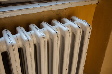 The old white radiator in an old run down house,