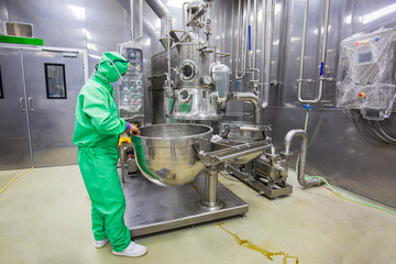 Male operation green protective clothes process in a food factory. the processing production line...