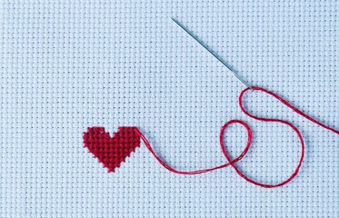 Heart wave embroidered with red thread on white cross stitch