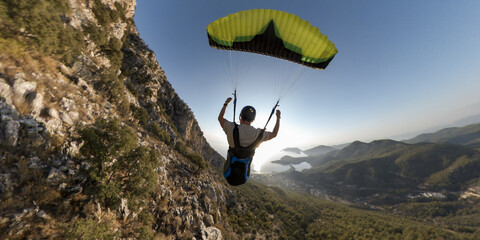 Extreme paraglider pilot flying at sunset in Turkey. Adventure concept