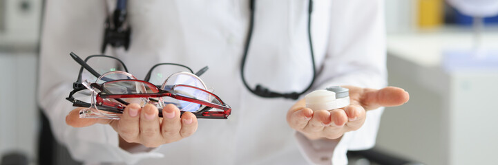 Female doctor making choice between contact lenses and glasses