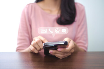 Contact us or contact customer support. Businessman using phone contact icon on virtual screen (email, address, chat)