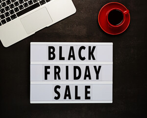 Creative promotion composition for Black friday with laptop on black background. Flat lay, top view, overhead, mockup, template. Minimal abstract background. Online shopping, sale, promo. Web banner