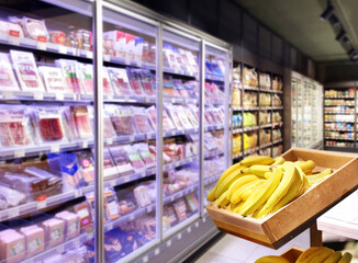 Fototapeta premium choosing a dairy products at supermarket.empty grocery cart in an empty supermarket