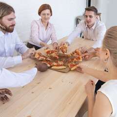 Business team eating pizza