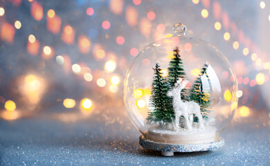 Christmas and New Year's composition in a glass ball on a background of side lights garlands.
