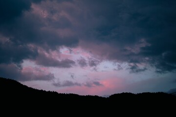 Silhouette shot of a mountain with a beautiful pink sky in the background
