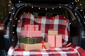 Car trunk full of gift boxes, presents and garland for Christmas holidays © Юля Шевцова