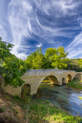 Romanesque bridge of Artigue and river Osse near Larressingle on route to Santiago de Compostela,...