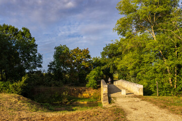 Romanesque bridge of Artigue and river Osse near Larressingle on route to Santiago de Compostela,...