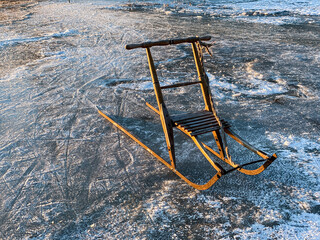 VIntage wooden kicksled on lake