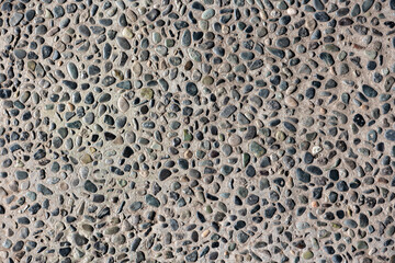 Pebbles in concrete texture or background