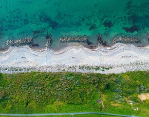 Aerial shot of Gilleleje beach with white sand and blue ocean water in Denmark