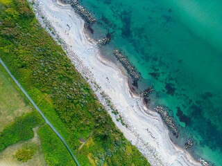 Aerial shot of Gilleleje beach with white sand and blue ocean water in Denmark