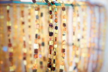 Amber beads on a glass shelf