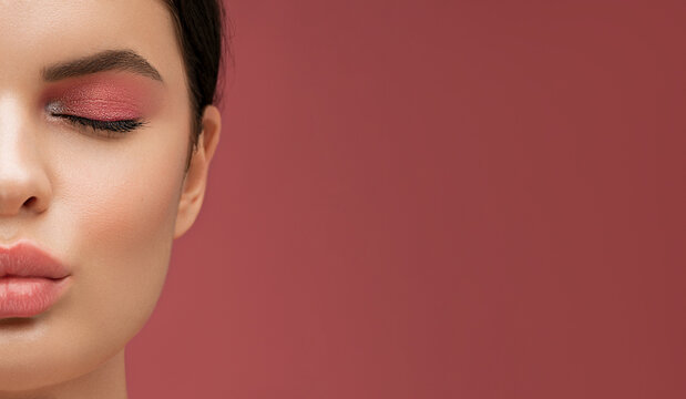 Pout lips. Beautiful young model with pink make up eye shadow, sending blowing kiss. Cuted view with a half of the famel face with copy space