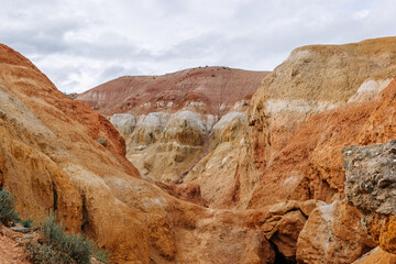Obraz premium View of the unrealistically beautiful colorful clay rocks in the Altai mountains, Russia. Fantasy martian landscape with colorful mountains
