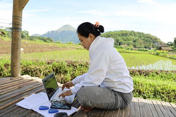Asian woman freelancer working with technology laptop with happiness action at Fantastic Landscape...
