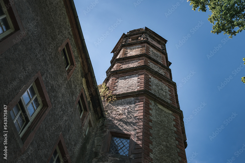 Aufkleber a tall brick building with a clock on the top of it's tower and a tree in the foreground.