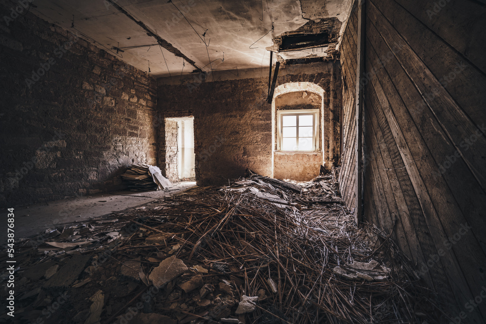 Poster a room with a bunch of debris in it and a window in the wall and a ladder in the corner.