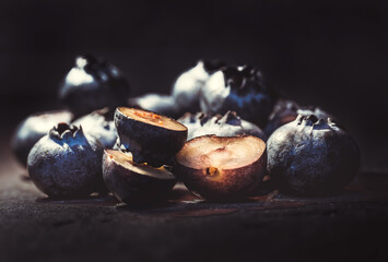Group of blueberries with two of them cut in half. everything in the foreground