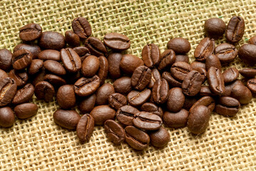 roasted coffee beans, on a burlap cloth, view from above
