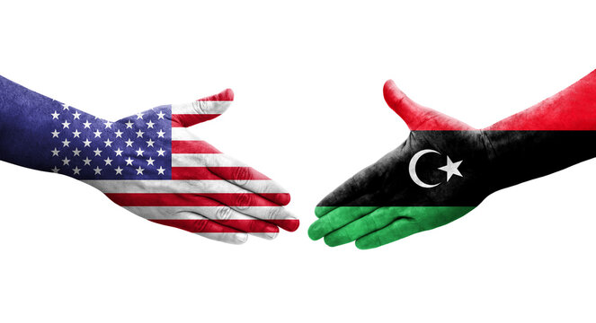 Handshake between Libya and USA flags painted on hands, isolated transparent image.