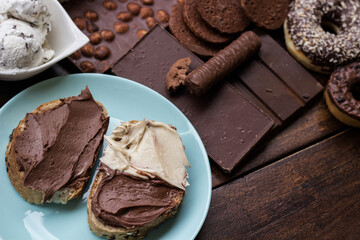 Chocolate cream on a bread and heap of a sweets
