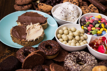 Chocolate cream on a bread and heap of a sweets