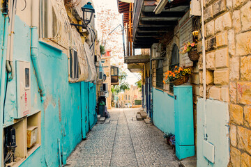 Charming streets of israel  Crete. Street in the old town of  Beautiful street in Safed, Israel, Summer landscape. Travel and vacation View of an alley in the Artists Quarter of the old city of Safed - obrazy, fototapety, plakaty
