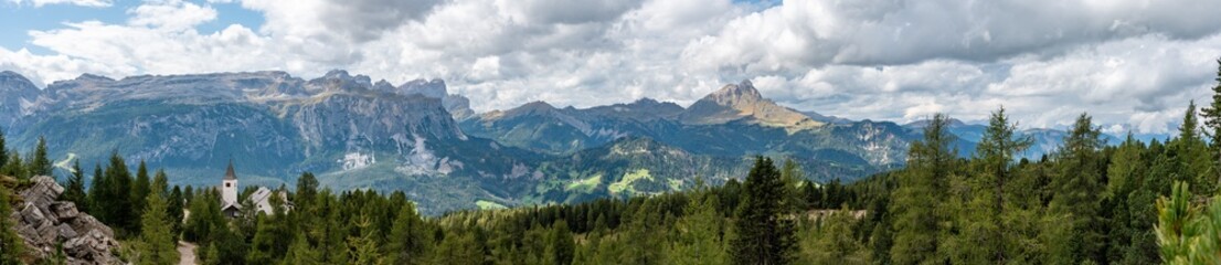 Panoramic landscape of the Dolomite Alps and the Heilig Kreuz church, South Tirol
