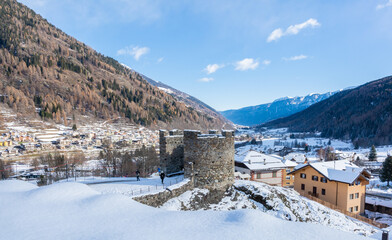 Fototapeta na wymiar St. Michael castle in Ossana stands on a rocky outcrop. Ossana castle in the village of Ossana in winter season - Sole Valley, Trento province, Trentino Alto Adige, northern Italy - december 7, 2021
