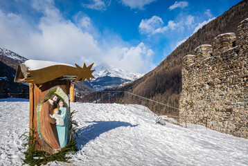 St. Michael castle in Ossana stands on a rocky outcrop. Ossana castle in the village of Ossana in winter season - Sole Valley, Trento province, Trentino Alto Adige, northern Italy - december 7, 2021