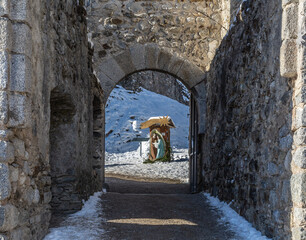 St. Michael castle in Ossana stands on a rocky outcrop. Ossana castle in the village of Ossana in winter season - Sole Valley, Trento province, Trentino Alto Adige, northern Italy - december 7, 2021