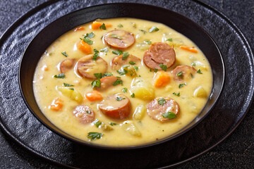 German potato soup with sausages in bowl