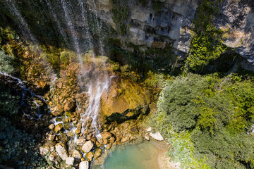 Fototapeta na wymiar Detail of the water stream of Sotira river with waterfall in Summer 2022, Albania