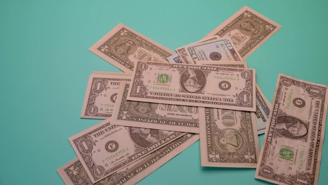 Flying money, Dollars falling from the sky on a green table.