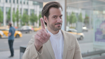 Rejecting Young Man Waving Finger in Denial Outdoor