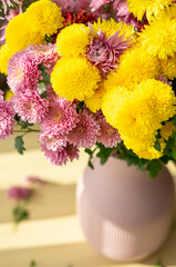 Autumn flowers in a pink vase
