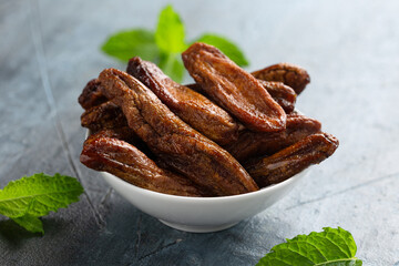 Sun dried bananas, healthy vegan vegetarian food snack concept.