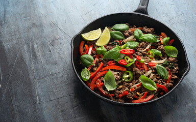 Pad Kra Pao stir fried thai basil, minced beef in iron cast pan