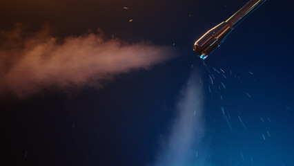 purging steam wand of coffee machine under neon lighting