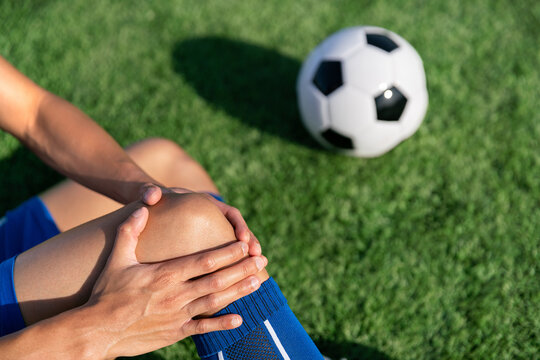 football soccer player accident knee injury sport treatment on champion league final match competition with ball on grass in stadium