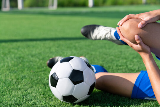 football soccer player accident knee injury sport treatment on champion league final match competition with ball on grass in stadium