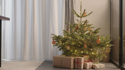 christmas gifts under spruce indoor with warm light