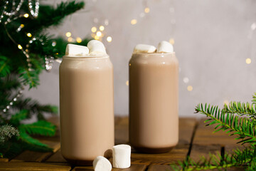 Cocoa with marshmallows in decoration with Christmas lights