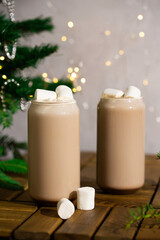 Cocoa with marshmallows in decoration with Christmas lights