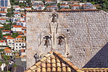 Details of walls, roof tiles and windows of yellow, orange and brown houses as seen in sunny day in...