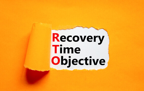 RTO recovery time objective symbol. Concept words RTO recovery time objective on white paper on a beautiful orange background. Business and RTO recovery time objective concept. Copy space.