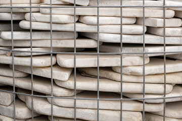polished flat marble stone in Basket Gabion Wall, wire fence filled with natural rock stones